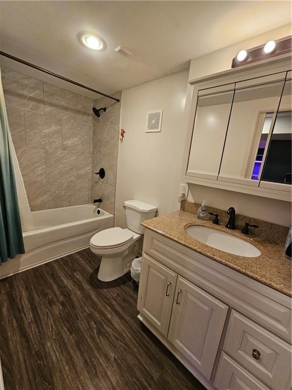 11306 E 45th St, Kansas City, MO 64133 - bathroom with vanity, shower / bath combo, toilet, and wood finished floors