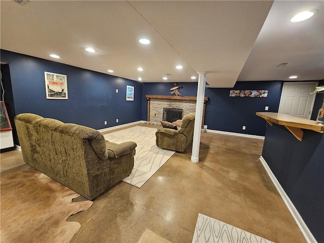11306 E 45th St, Kansas City, MO 64133 - living area with recessed lighting, finished concrete flooring, baseboards, and a fireplace with raised hearth