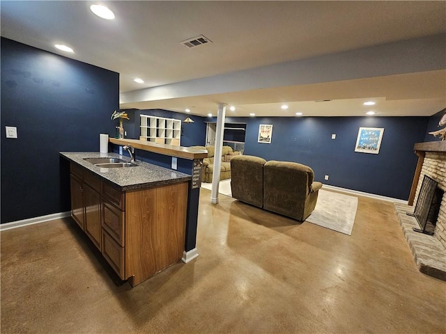 11306 E 45th St, Kansas City, MO 64133 - indoor bar featuring a fireplace with raised hearth, concrete floors, baseboards, and recessed lighting