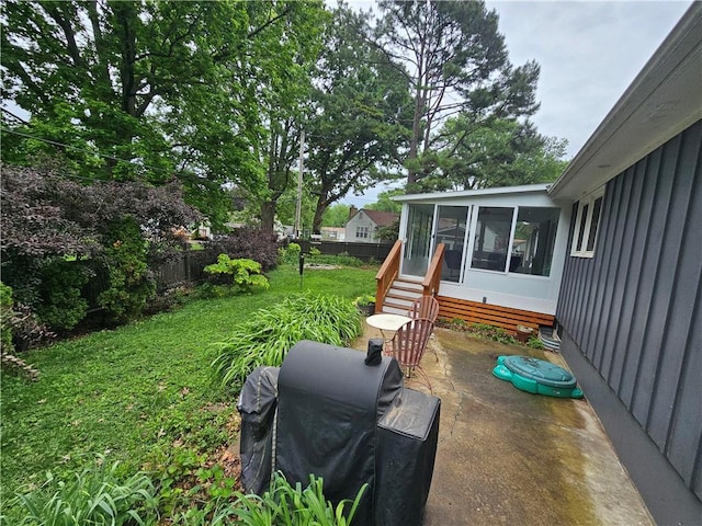 11306 E 45th St, Kansas City, MO 64133 - view of yard with a sunroom and a patio