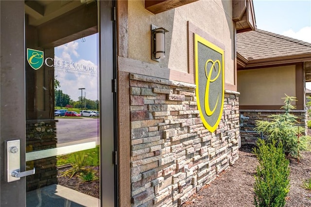 602 Mayfair Ct, Raymore, MO 64082 - exterior view of stucco siding, stone siding, and roof with shingles