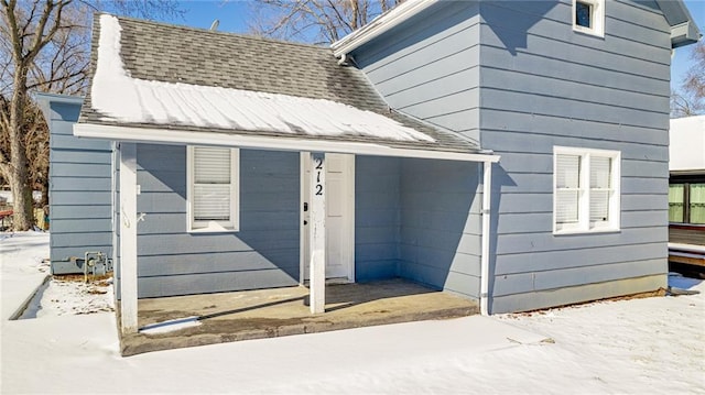 212 S Delaware St, Tonganoxie, KS 66086 - snow covered property with a shingled roof