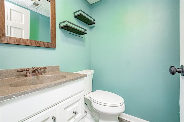 212 S Delaware St, Tonganoxie, KS 66086 - bathroom featuring vanity, toilet, and baseboards