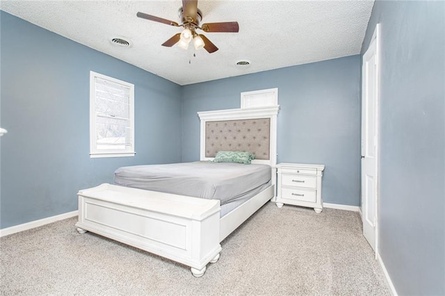 212 S Delaware St, Tonganoxie, KS 66086 - bedroom with light carpet, a textured ceiling, baseboards, and a ceiling fan