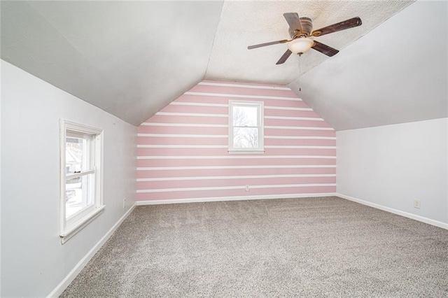 212 S Delaware St, Tonganoxie, KS 66086 - additional living space featuring plenty of natural light, lofted ceiling, ceiling fan, carpet floors, and baseboards