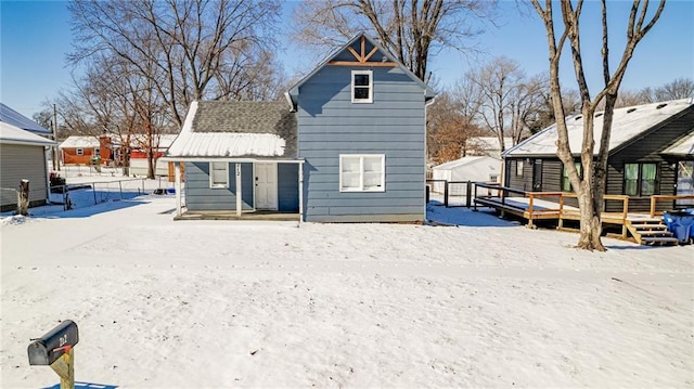 212 S Delaware St, Tonganoxie, KS 66086 - snow covered property with a wooden deck
