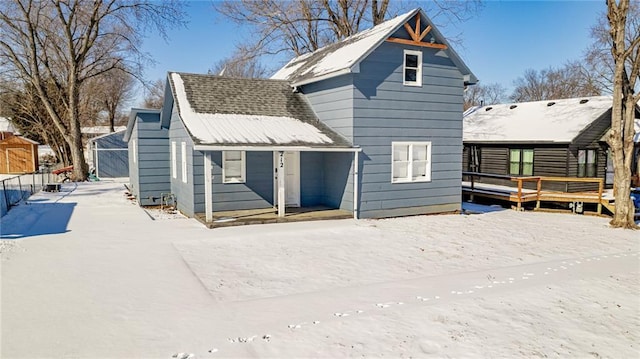 212 S Delaware St, Tonganoxie, KS 66086 - snow covered house featuring a wooden deck and a shingled roof