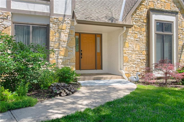 17725 W 68th Ter, Shawnee, KS 66217 - entrance to property featuring stone siding, a shingled roof, and stucco siding