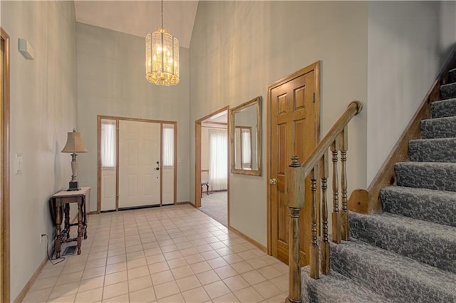17725 W 68th Ter, Shawnee, KS 66217 - foyer featuring high vaulted ceiling, a chandelier, stairway, light tile patterned flooring, and baseboards