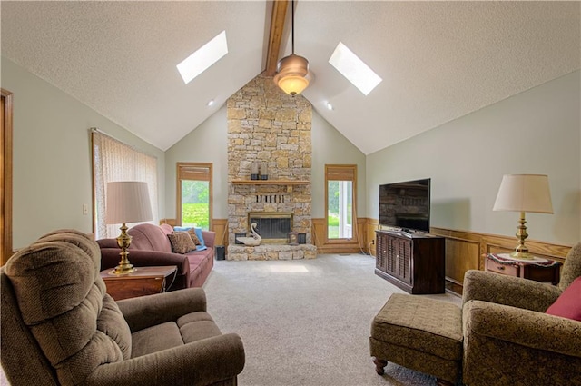 17725 W 68th Ter, Shawnee, KS 66217 - living room with a skylight, plenty of natural light, a fireplace, a wainscoted wall, and beam ceiling