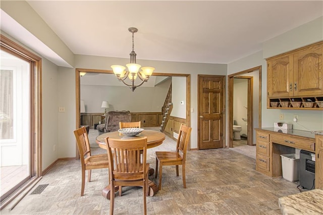 17725 W 68th Ter, Shawnee, KS 66217 - dining area featuring a chandelier and light stone finish flooring