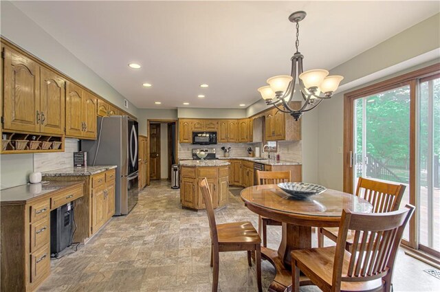 17725 W 68th Ter, Shawnee, KS 66217 - dining room featuring a chandelier, recessed lighting, and light stone finish flooring