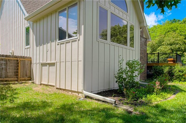 17725 W 68th Ter, Shawnee, KS 66217 - view of side of property with board and batten siding, roof with shingles, a garage, and a deck