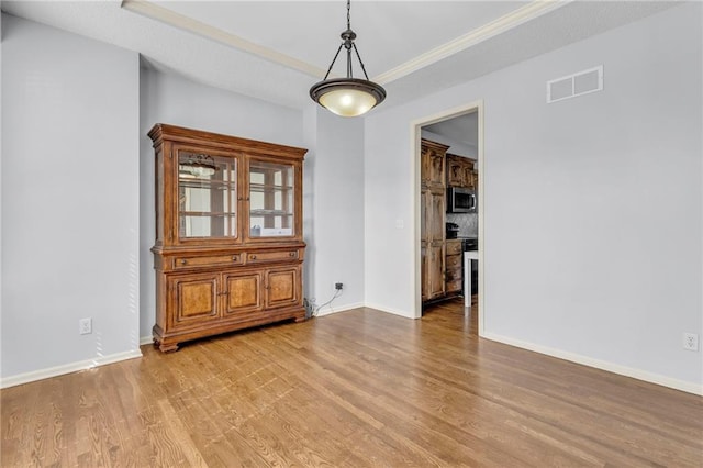 635 N Laurel St, Gardner, KS 66030 - spare room featuring wood finished floors, baseboards, and ornamental molding