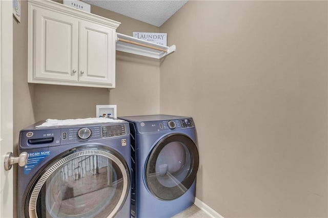 635 N Laurel St, Gardner, KS 66030 - laundry room featuring washing machine and dryer, cabinet space, baseboards, a textured ceiling, and tile patterned flooring