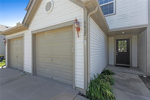 5412 Fairmount Ave, Kansas City, MO 64118 - view of exterior entry featuring concrete driveway and a garage