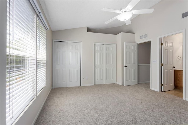 5412 Fairmount Ave, Kansas City, MO 64118 - unfurnished bedroom with carpet, lofted ceiling, multiple closets, baseboards, and a ceiling fan