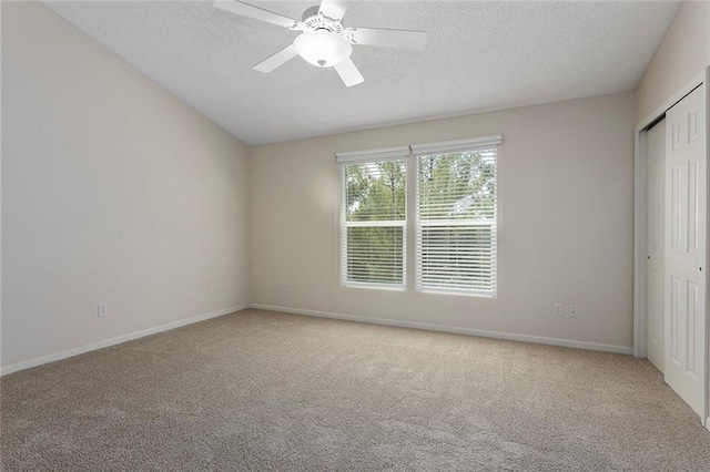5412 Fairmount Ave, Kansas City, MO 64118 - unfurnished bedroom featuring carpet, a textured ceiling, a closet, baseboards, and a ceiling fan
