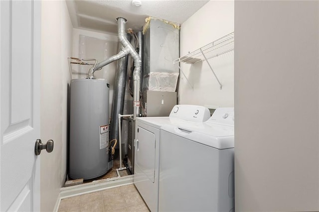 5412 Fairmount Ave, Kansas City, MO 64118 - washroom featuring water heater, separate washer and dryer, and tile patterned flooring