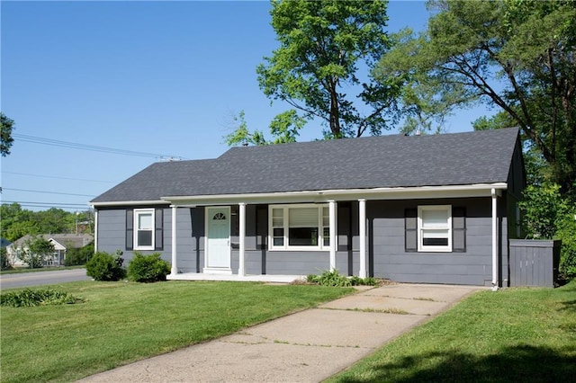 7048 Horton St, Overland Park, KS 66204 - view of front facade featuring a front lawn, covered porch, and a shingled roof