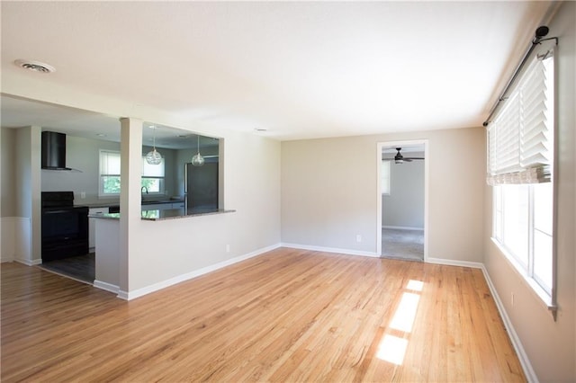 7048 Horton St, Overland Park, KS 66204 - empty room with light wood-style floors, a ceiling fan, and baseboards