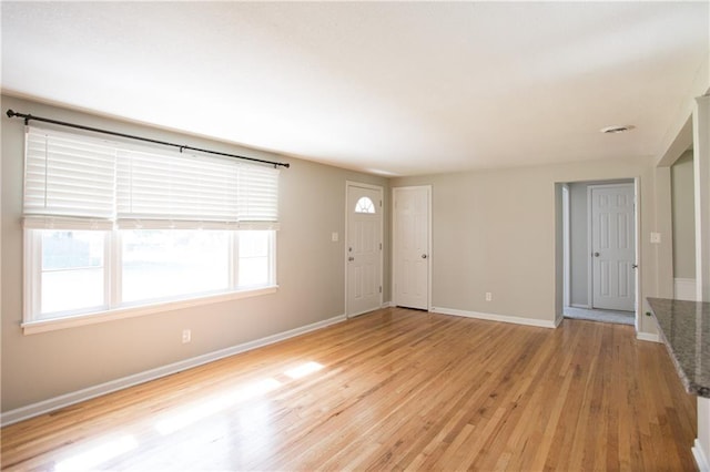 7048 Horton St, Overland Park, KS 66204 - unfurnished living room featuring light wood-type flooring and baseboards