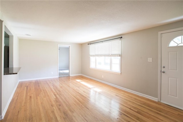 7048 Horton St, Overland Park, KS 66204 - foyer featuring light wood-style floors, healthy amount of natural light, and baseboards