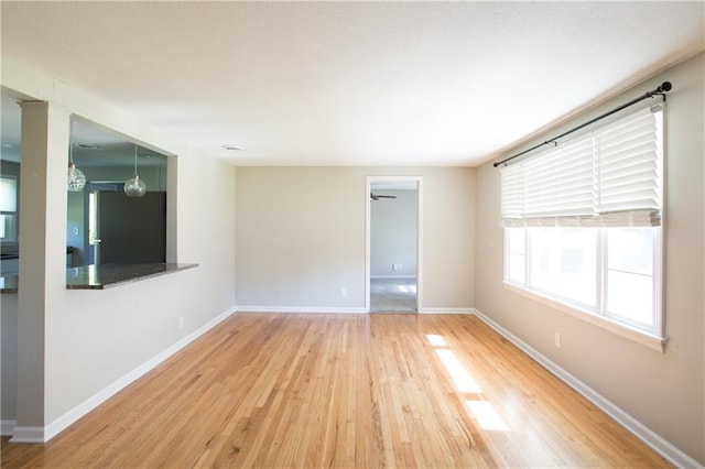 7048 Horton St, Overland Park, KS 66204 - unfurnished room with wood finished floors, baseboards, and a ceiling fan