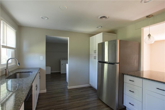 7048 Horton St, Overland Park, KS 66204 - kitchen featuring a sink, freestanding refrigerator, washer / dryer, dishwasher, and white cabinetry