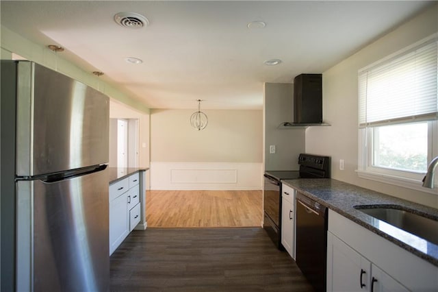7048 Horton St, Overland Park, KS 66204 - kitchen with black appliances, range hood, a sink, dark wood finished floors, and dark stone countertops