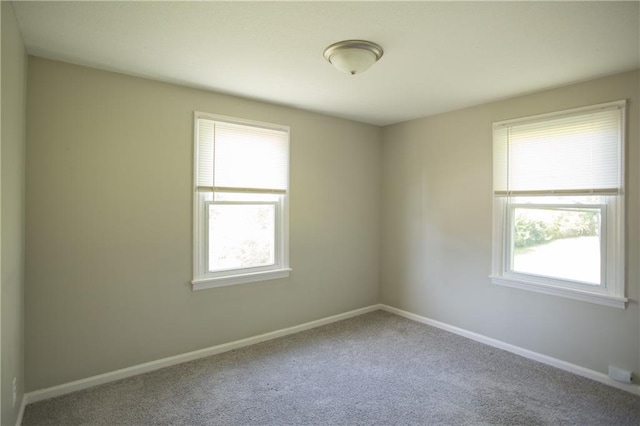 7048 Horton St, Overland Park, KS 66204 - carpeted empty room featuring healthy amount of natural light and baseboards