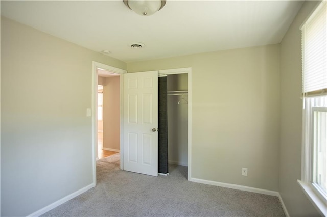 7048 Horton St, Overland Park, KS 66204 - unfurnished bedroom with light carpet, multiple windows, and baseboards