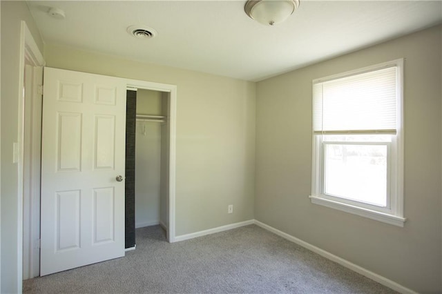 7048 Horton St, Overland Park, KS 66204 - unfurnished bedroom featuring a closet, baseboards, and carpet