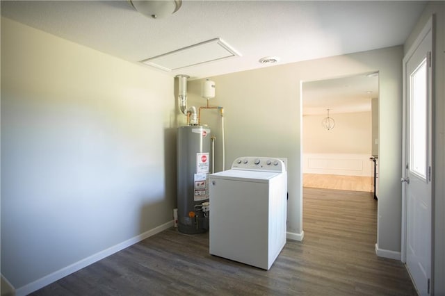 7048 Horton St, Overland Park, KS 66204 - washroom with washer / dryer, water heater, dark wood-style flooring, attic access, and baseboards