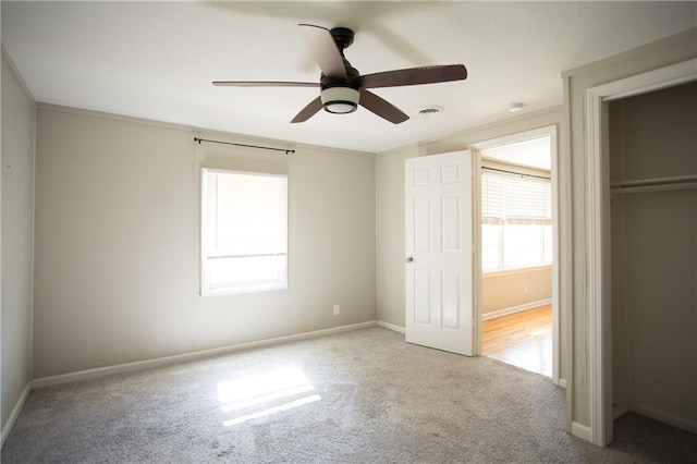 7048 Horton St, Overland Park, KS 66204 - unfurnished bedroom with multiple windows, carpet flooring, baseboards, and ceiling fan