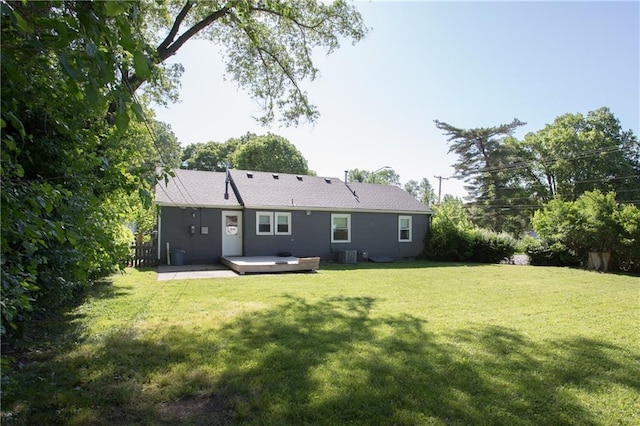 7048 Horton St, Overland Park, KS 66204 - back of house with a lawn, central air condition unit, and a deck