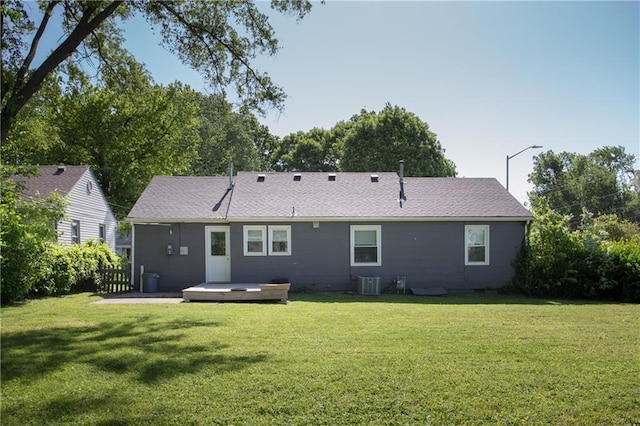 7048 Horton St, Overland Park, KS 66204 - back of house with central AC, roof with shingles, and a wooden deck