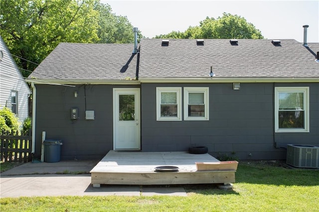 7048 Horton St, Overland Park, KS 66204 - rear view of property featuring a wooden deck, roof with shingles, and central air condition unit