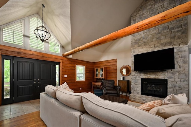 611 N Winnebago Dr, Lake Winnebago, MO 64034 - living room featuring high vaulted ceiling, a fireplace, a chandelier, and wood finished floors