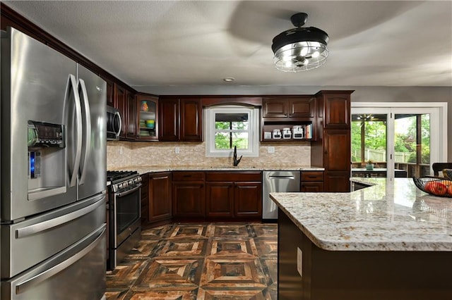 611 N Winnebago Dr, Lake Winnebago, MO 64034 - kitchen featuring stainless steel appliances, a sink, decorative backsplash, and dark brown cabinets