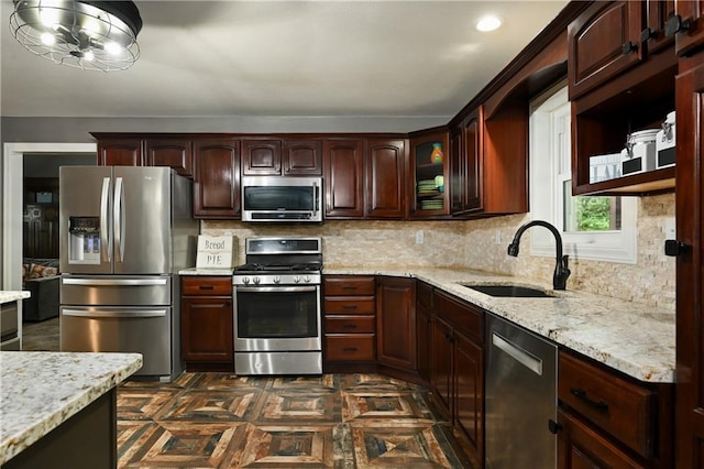 611 N Winnebago Dr, Lake Winnebago, MO 64034 - kitchen with stainless steel appliances, a sink, light stone countertops, and backsplash