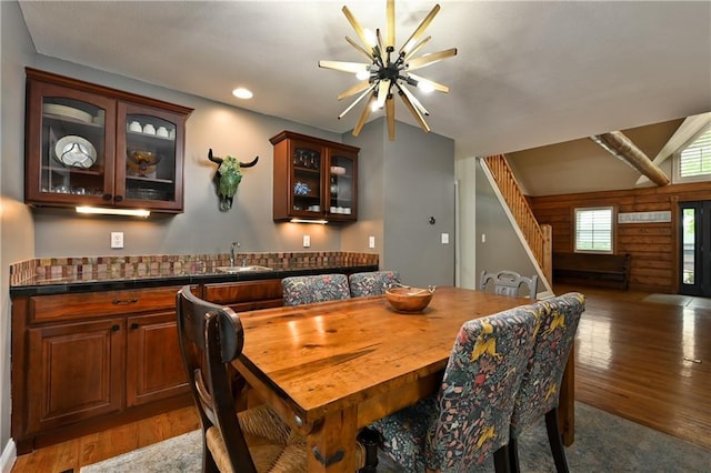 611 N Winnebago Dr, Lake Winnebago, MO 64034 - dining area featuring stairs, light wood finished floors, wet bar, recessed lighting, and wood walls