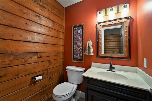 611 N Winnebago Dr, Lake Winnebago, MO 64034 - bathroom with toilet, vanity, and wood walls