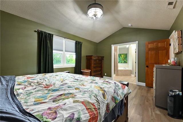 611 N Winnebago Dr, Lake Winnebago, MO 64034 - bedroom with vaulted ceiling, light wood-style floors, and ensuite bathroom