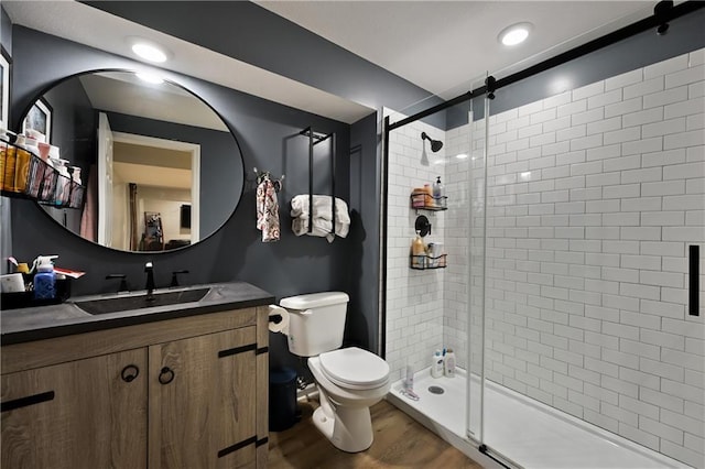 611 N Winnebago Dr, Lake Winnebago, MO 64034 - bathroom with vanity, toilet, a shower stall, and wood finished floors