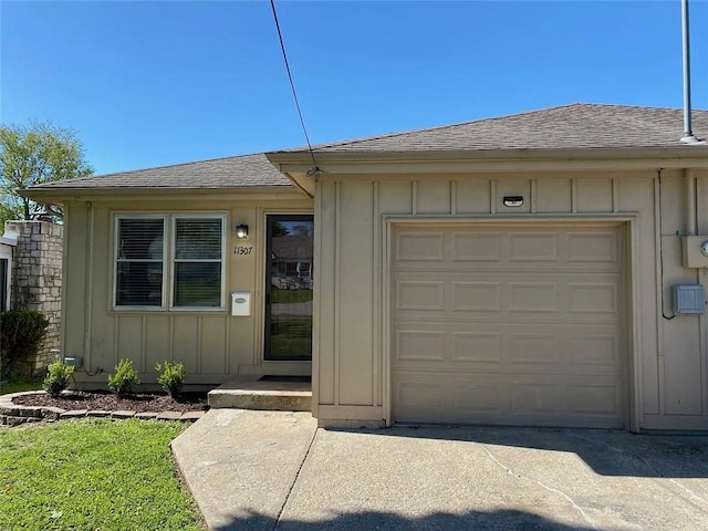 11307 W 60th St, Shawnee, KS 66203 - view of front facade featuring board and batten siding, roof with shingles, and concrete driveway