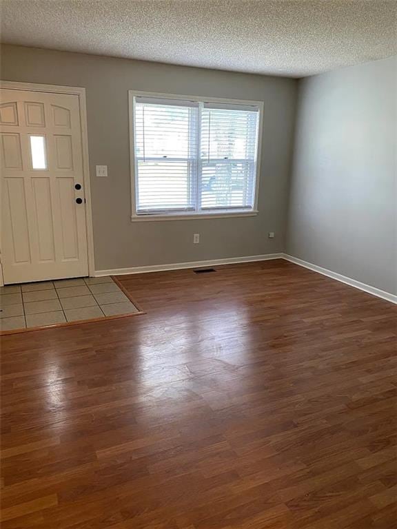 11307 W 60th St, Shawnee, KS 66203 - entryway featuring wood finished floors, a textured ceiling, and baseboards