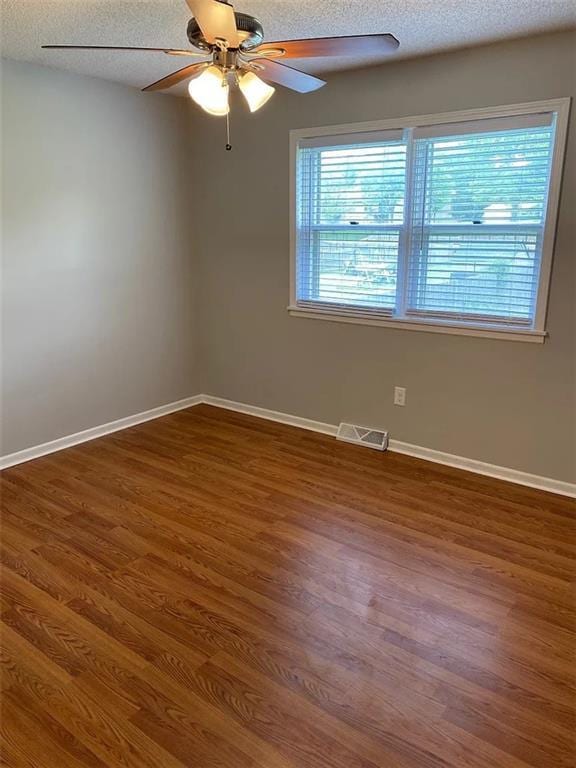 11307 W 60th St, Shawnee, KS 66203 - unfurnished room featuring plenty of natural light, a ceiling fan, wood finished floors, and a textured ceiling