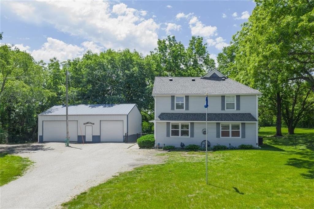 14775 Hillside Rd, Leavenworth, KS 66048 - view of front of property with an outbuilding, a garage, and a front yard