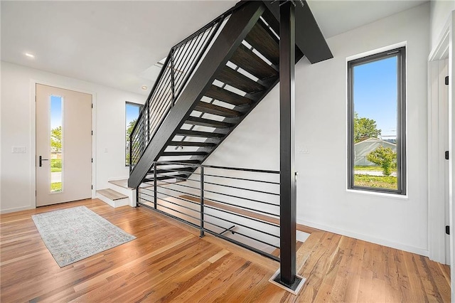 entryway featuring healthy amount of natural light, light wood-style floors, baseboards, and recessed lighting